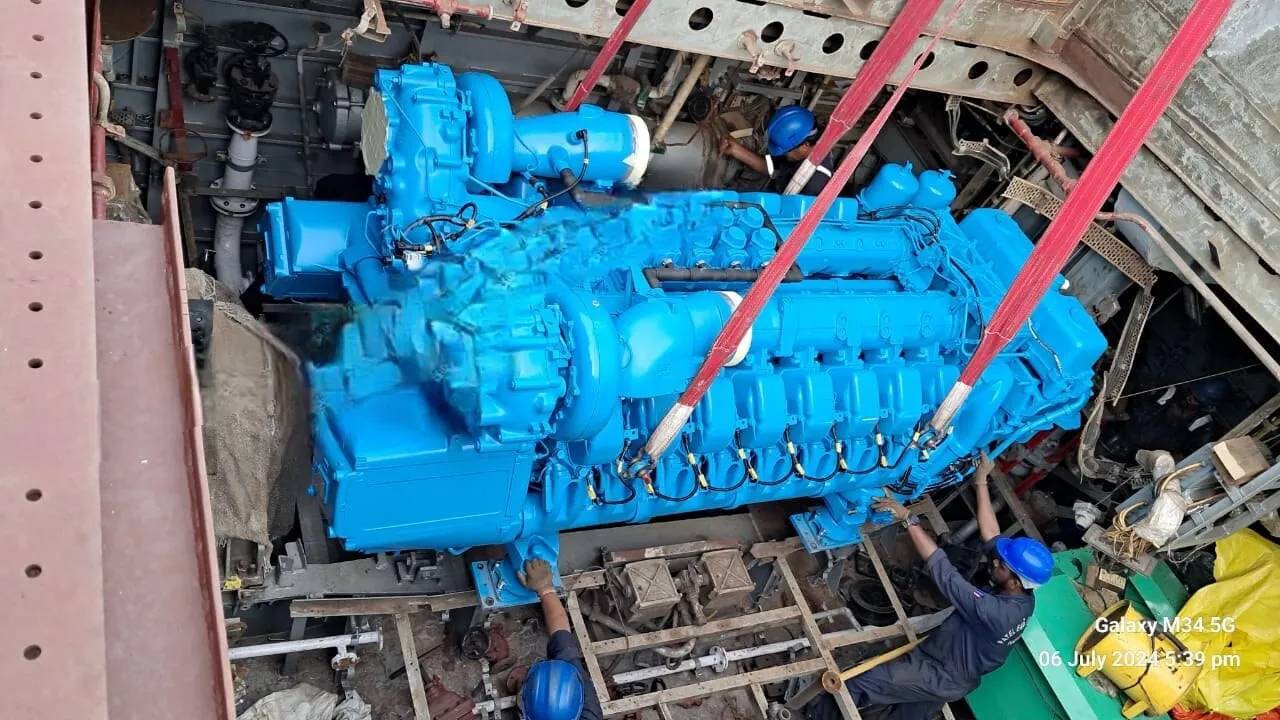 Main engine handled into the machinery space during a refit.