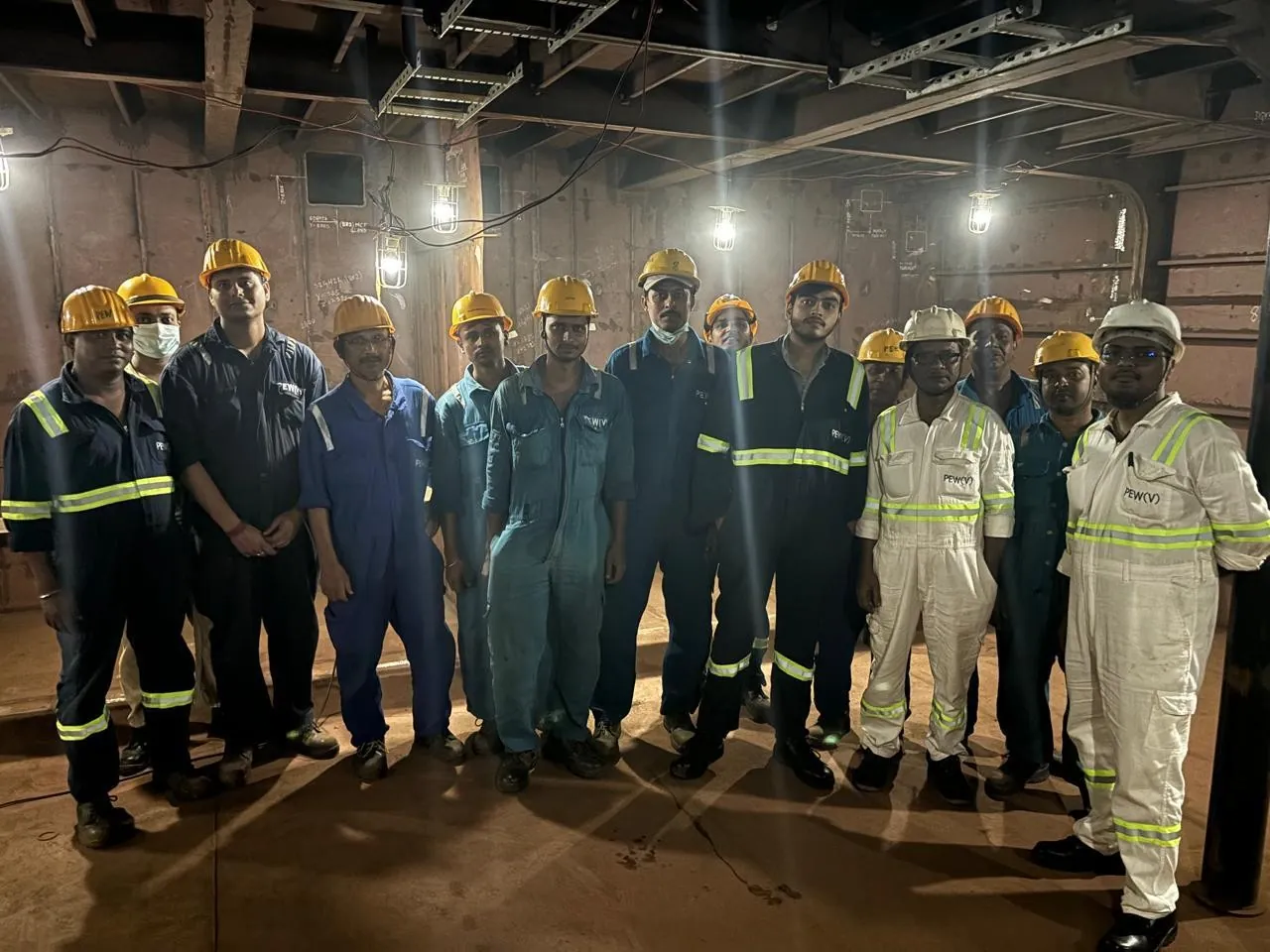 Shipbuilding team inside a fabricated ship compartment.