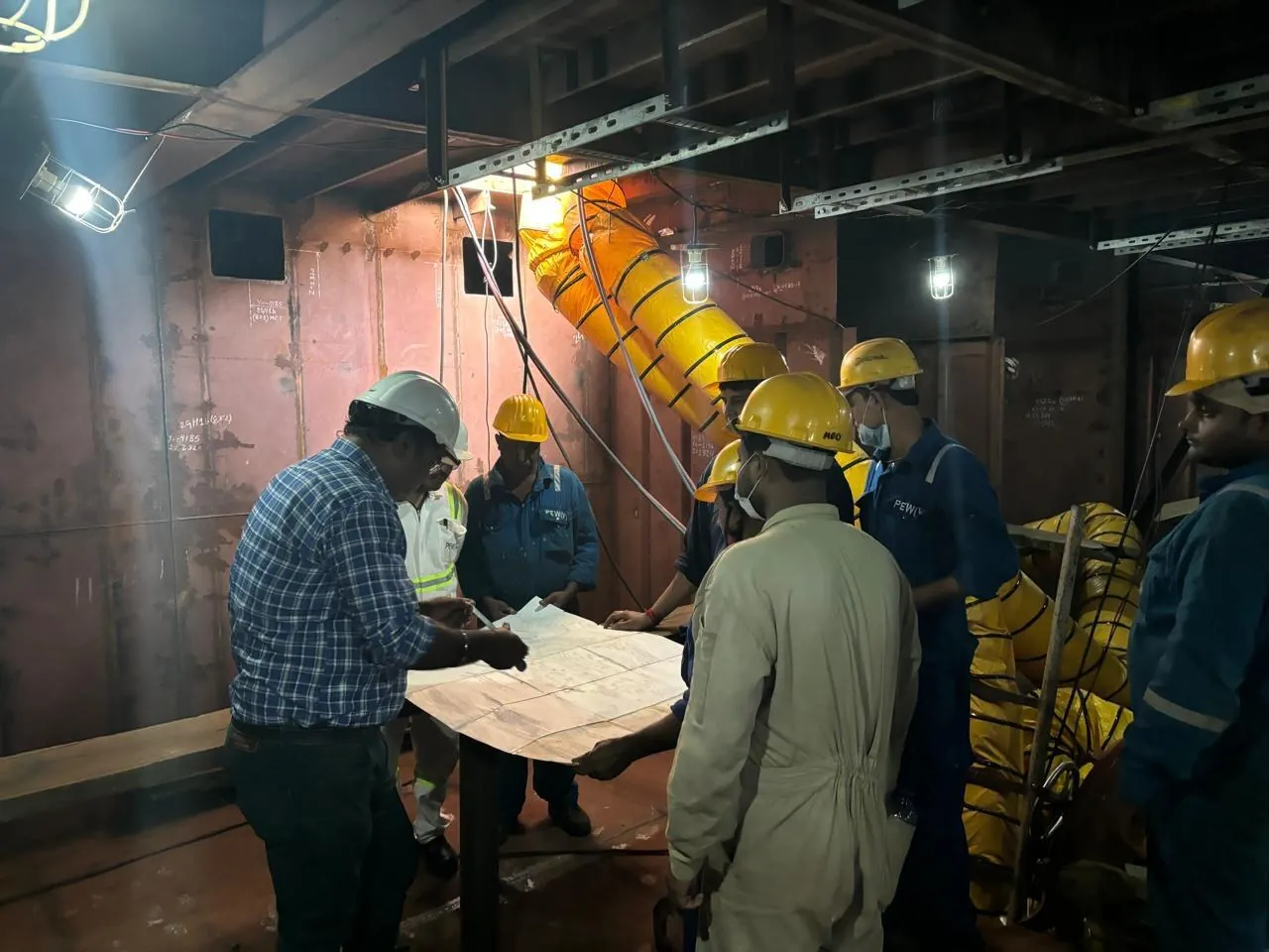 Patel Engineering Works supervisors reviewing drawings on site