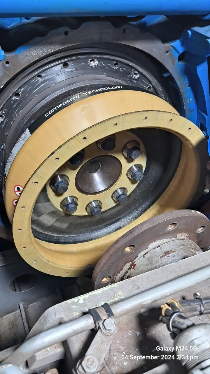 Engine–gearbox flexible coupling positioned for final connection and alignment.